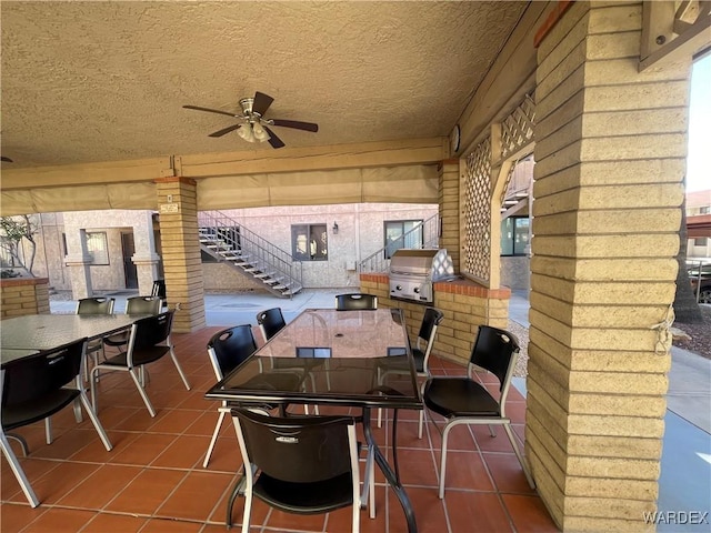 view of patio / terrace featuring ceiling fan, a grill, stairs, and outdoor dining area