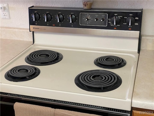 room details featuring light countertops and range with electric stovetop