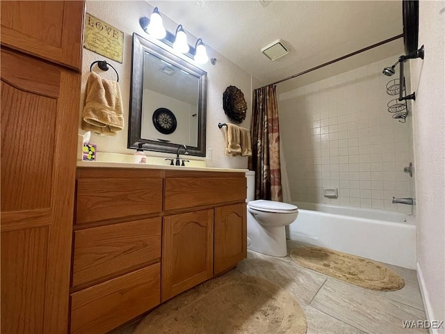 bathroom with toilet, shower / tub combo, visible vents, and vanity