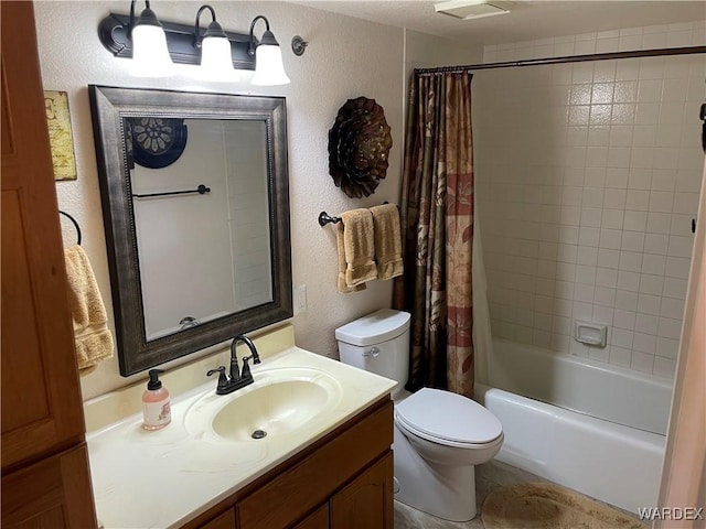 bathroom with shower / tub combo with curtain, a textured wall, vanity, and toilet