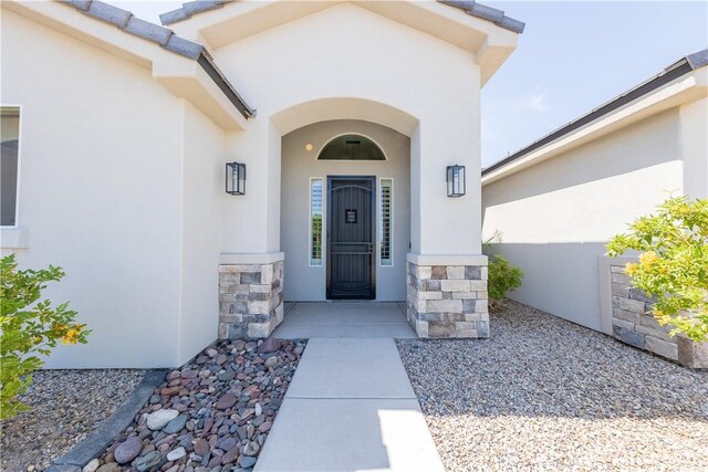 2178 E Via Lucio, Fort Mohave, AZ 86426 - doorway to property featuring stucco siding and stone siding