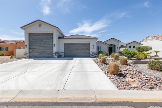 2178 E Via Lucio, Fort Mohave, AZ 86426 - ranch-style home with an attached garage, stone siding, driveway, stucco siding, and a tiled roof