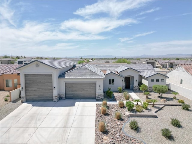 2178 E Via Lucio, Fort Mohave, AZ 86426 - ranch-style home featuring a garage, stucco siding, stone siding, driveway, and a tiled roof
