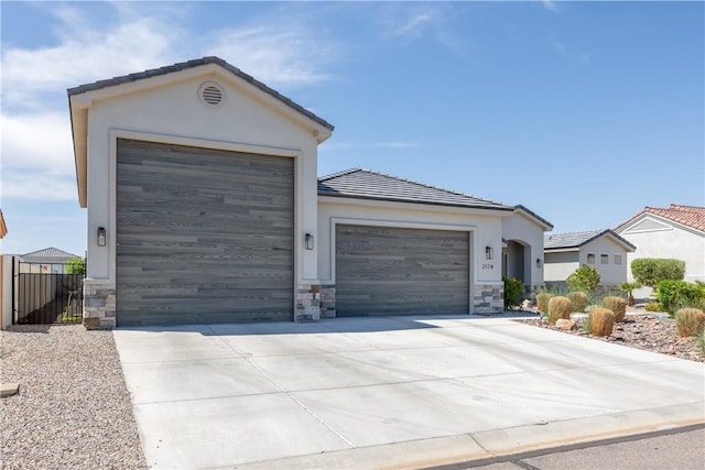 2178 E Via Lucio, Fort Mohave, AZ 86426 - single story home with stone siding, stucco siding, an attached garage, and a tile roof