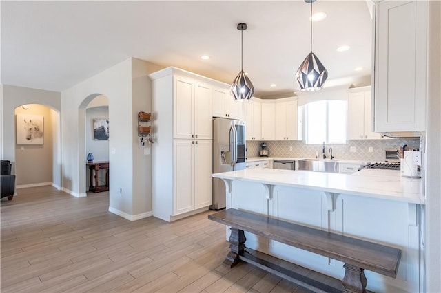 2178 E Via Lucio, Fort Mohave, AZ 86426 - kitchen with appliances with stainless steel finishes, a peninsula, light countertops, backsplash, and recessed lighting
