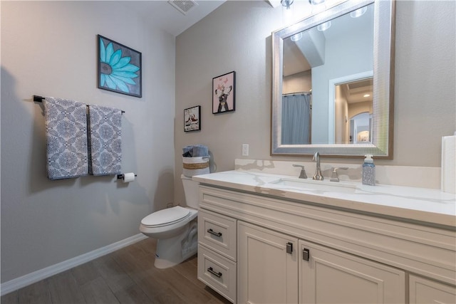 2178 E Via Lucio, Fort Mohave, AZ 86426 - bathroom featuring wood finished floors, vanity, toilet, and baseboards