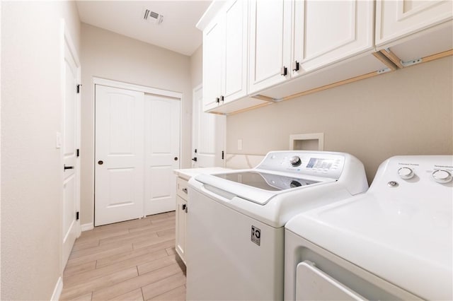 2178 E Via Lucio, Fort Mohave, AZ 86426 - washroom featuring separate washer and dryer, cabinet space, light wood-style floors, and baseboards
