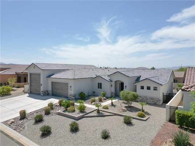 2178 E Via Lucio, Fort Mohave, AZ 86426 - ranch-style home with stucco siding, a garage, driveway, stone siding, and a tile roof