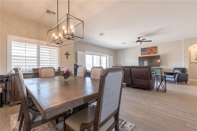 2178 E Via Lucio, Fort Mohave, AZ 86426 - dining room with light wood finished floors, ceiling fan, and a chandelier