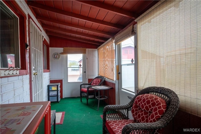 sunroom featuring vaulted ceiling with beams and wooden ceiling