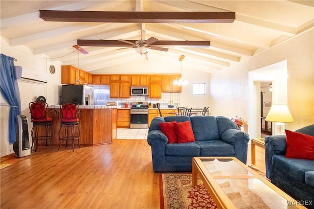 living area with vaulted ceiling with beams, ceiling fan, and light wood-style floors