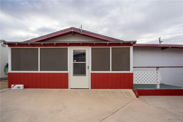 view of front of property with a patio and a sunroom