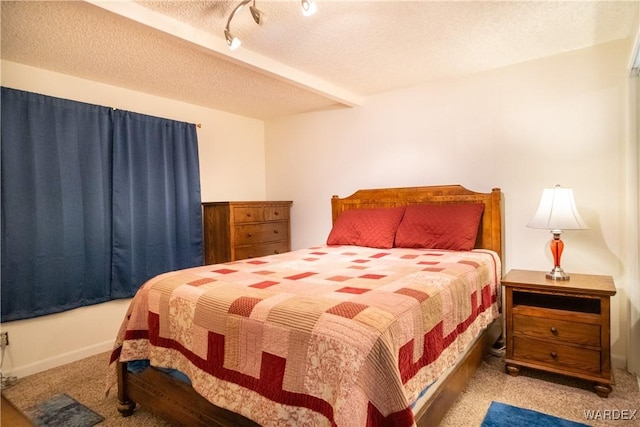 bedroom featuring a textured ceiling and light colored carpet