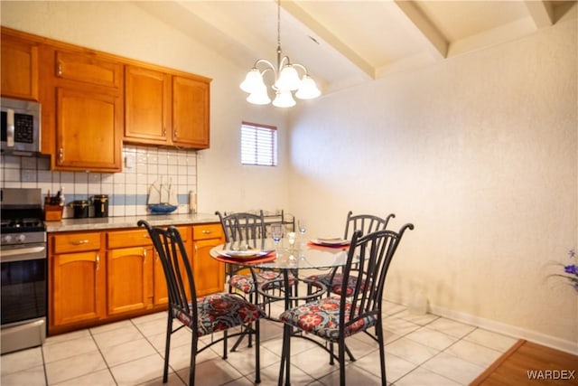 kitchen featuring vaulted ceiling with beams, stainless steel appliances, tasteful backsplash, light countertops, and hanging light fixtures