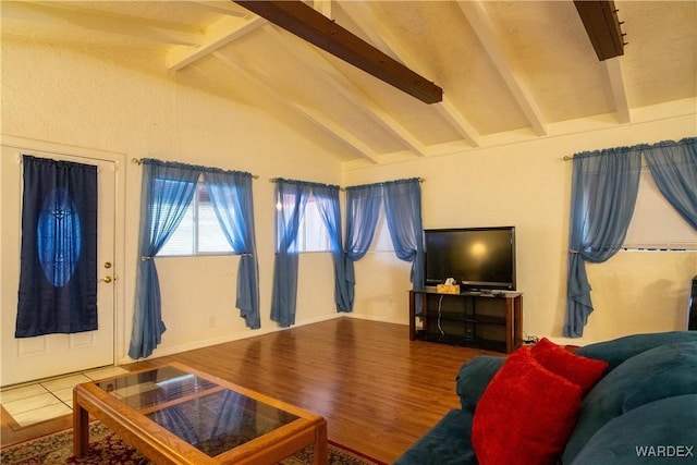 living room featuring lofted ceiling with beams and wood finished floors