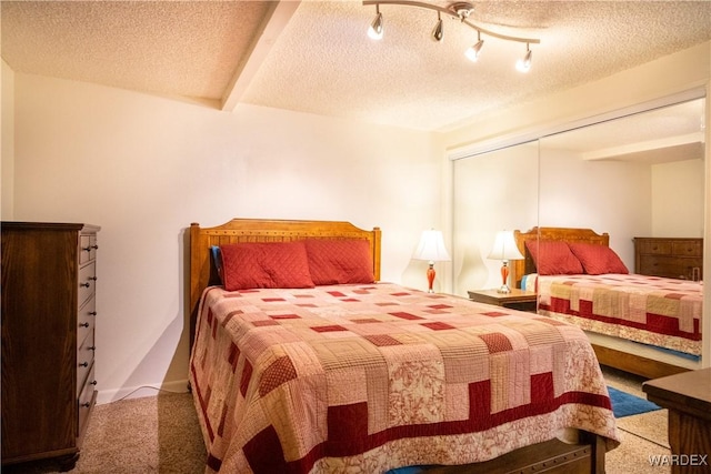 carpeted bedroom featuring a textured ceiling and beamed ceiling