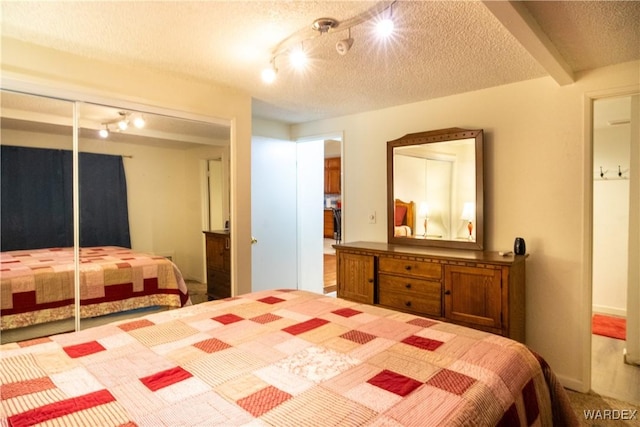 bedroom with a closet and a textured ceiling