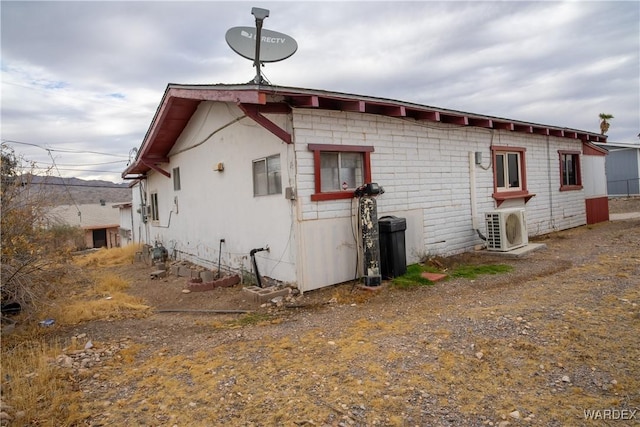 view of side of property with ac unit