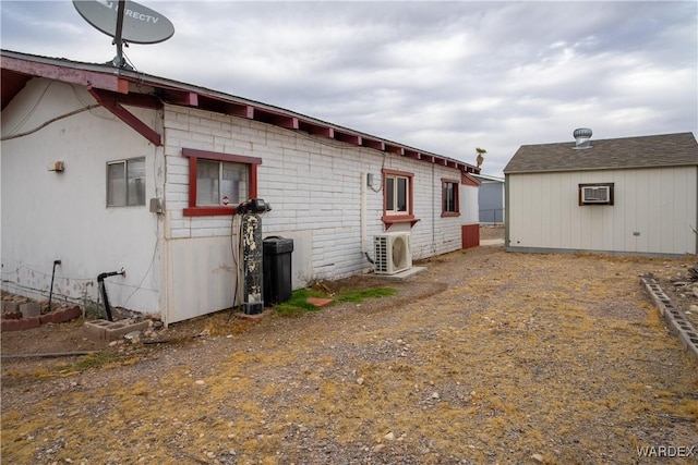 view of side of home featuring ac unit