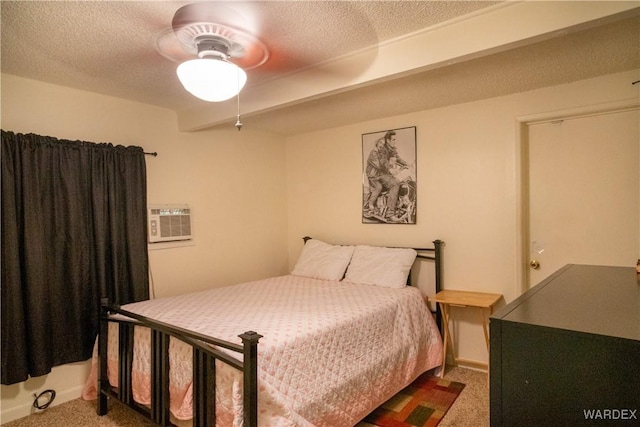 bedroom featuring carpet floors, a wall unit AC, ceiling fan, and a textured ceiling