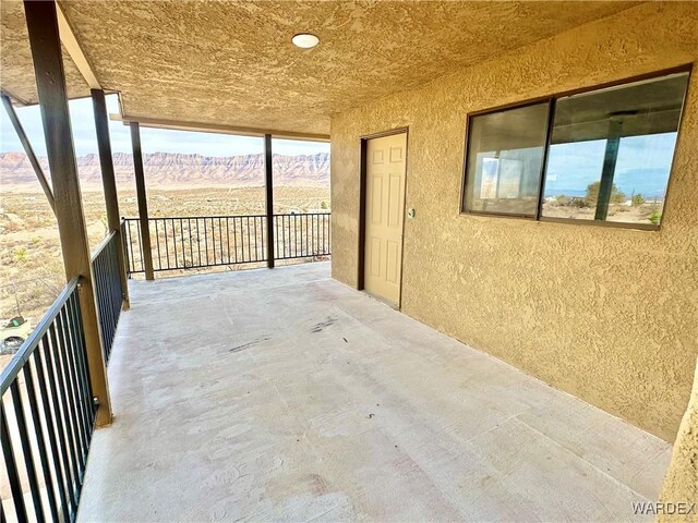 view of patio / terrace featuring a balcony and a mountain view