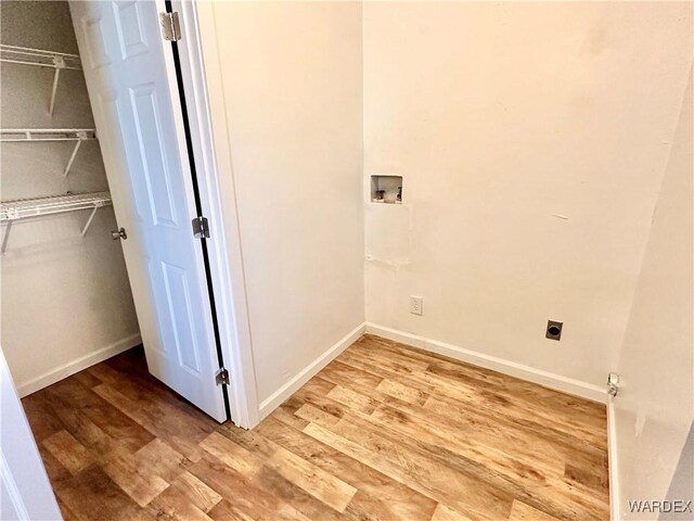 laundry area featuring laundry area, washer hookup, wood finished floors, baseboards, and electric dryer hookup