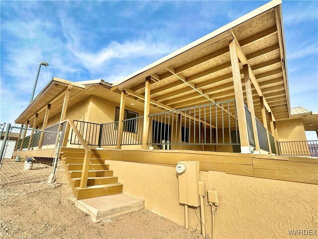 view of side of property featuring an exterior structure and stucco siding