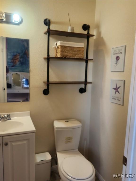 bathroom with toilet and vanity