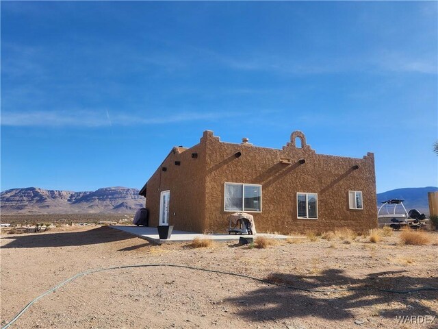 view of home's exterior featuring a mountain view and stucco siding