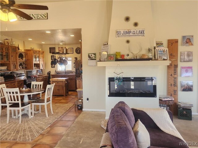 living area with recessed lighting, baseboards, a ceiling fan, and tile patterned floors