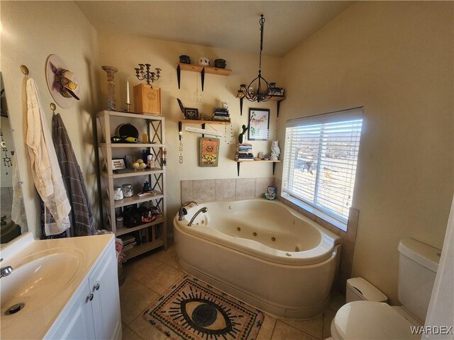 bathroom featuring a whirlpool tub, tile patterned flooring, toilet, and vanity