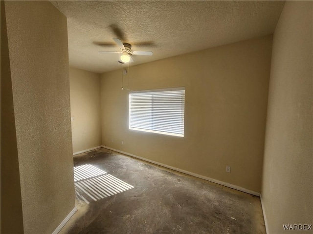 unfurnished room with baseboards, a textured ceiling, unfinished concrete floors, and ceiling fan