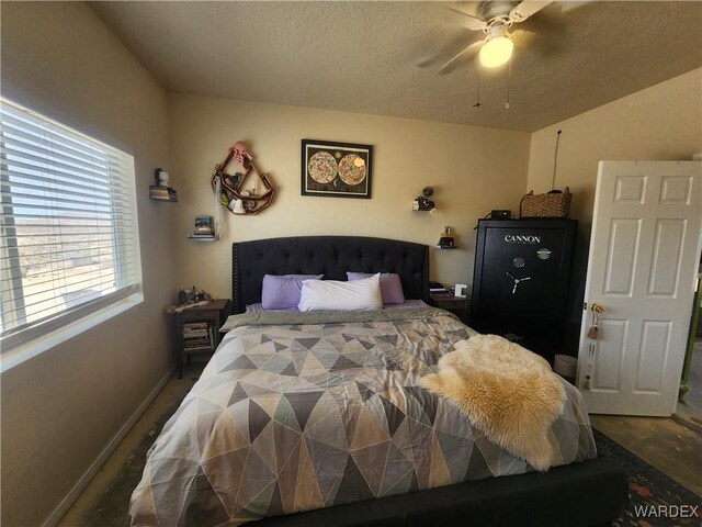 bedroom featuring ceiling fan, baseboards, and a textured ceiling