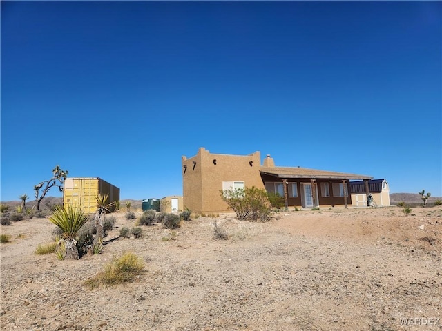 back of house featuring stucco siding