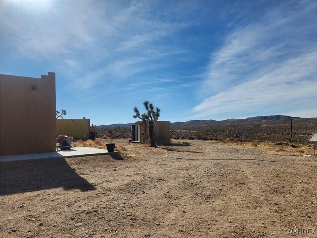 view of yard with a patio area and a mountain view