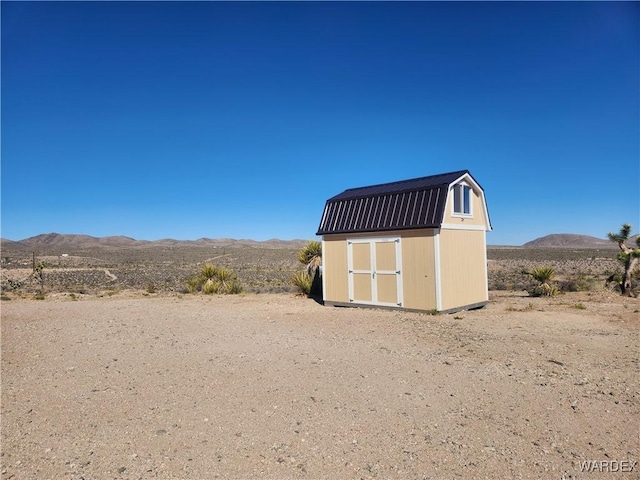 view of shed featuring a desert view and a mountain view