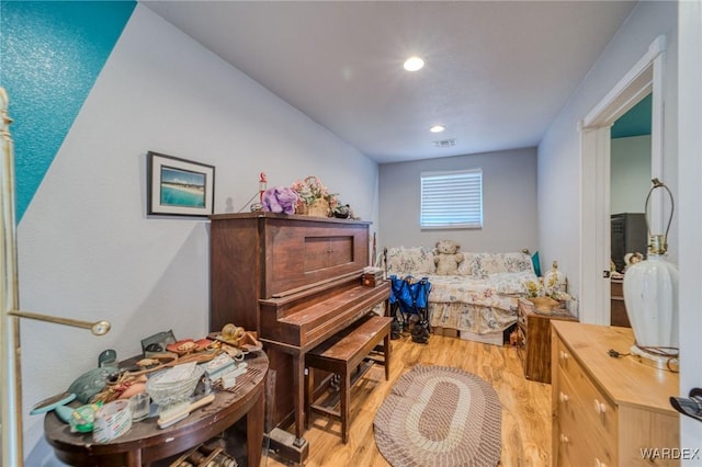 bedroom featuring light wood-type flooring and visible vents