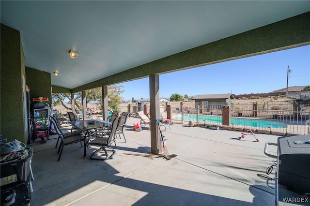 view of patio featuring fence and a community pool