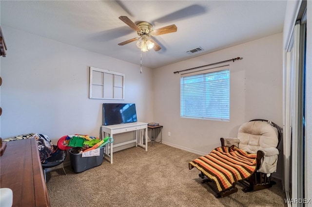 interior space featuring a ceiling fan, light colored carpet, visible vents, and baseboards