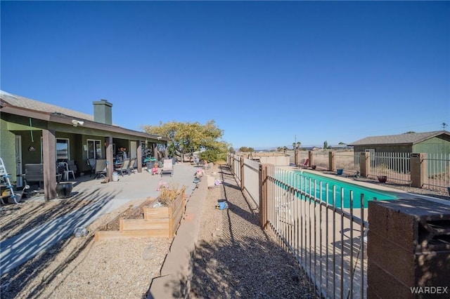 view of swimming pool with fence, a fenced in pool, and a patio