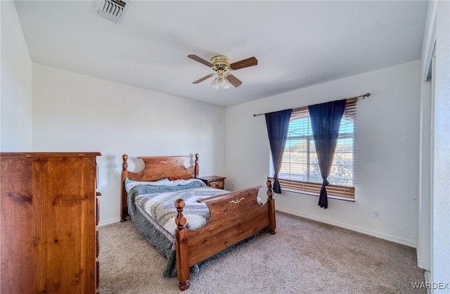 bedroom featuring a ceiling fan, light carpet, visible vents, and baseboards