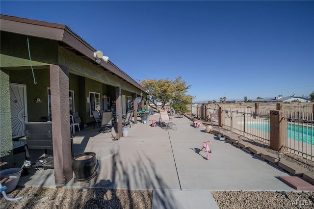 view of yard with a patio area, a community pool, and fence