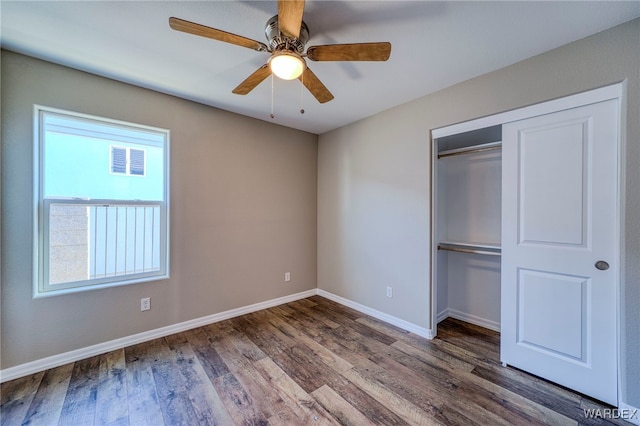 unfurnished bedroom featuring ceiling fan, visible vents, baseboards, a closet, and dark wood finished floors