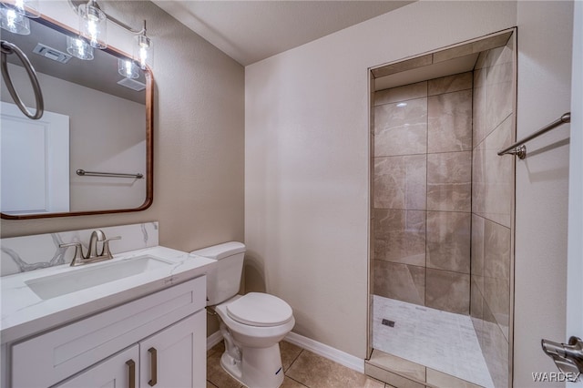 bathroom with toilet, visible vents, vanity, a tile shower, and tile patterned floors