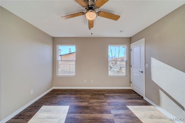 unfurnished room featuring dark wood-type flooring, baseboards, and a ceiling fan