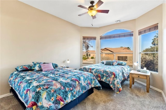 bedroom featuring carpet floors, a ceiling fan, visible vents, and baseboards