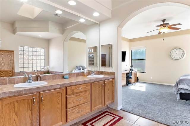 full bathroom with double vanity, visible vents, a sink, and tile patterned floors