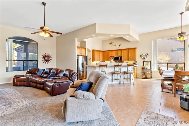 living area with recessed lighting, ceiling fan, baseboards, and light tile patterned flooring