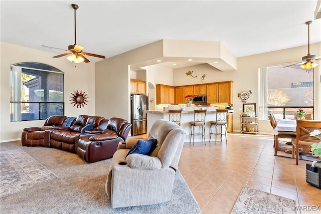 living area with recessed lighting, ceiling fan, baseboards, and light tile patterned flooring