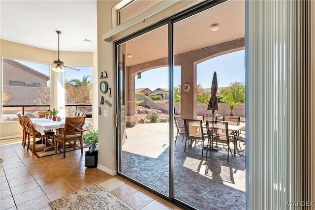 entryway with light tile patterned floors, visible vents, a wealth of natural light, and baseboards